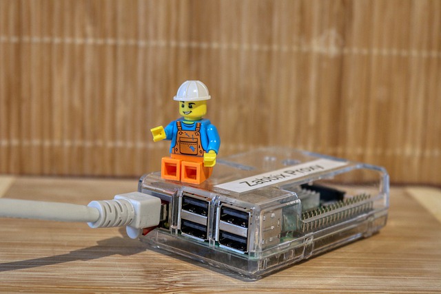 A Lego man sitting on a Raspberry Pi